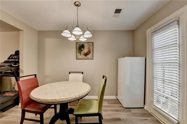 a view of a dining room with furniture wooden floor and a chandelier