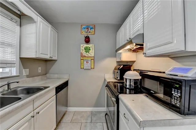 a kitchen with a sink cabinets and window