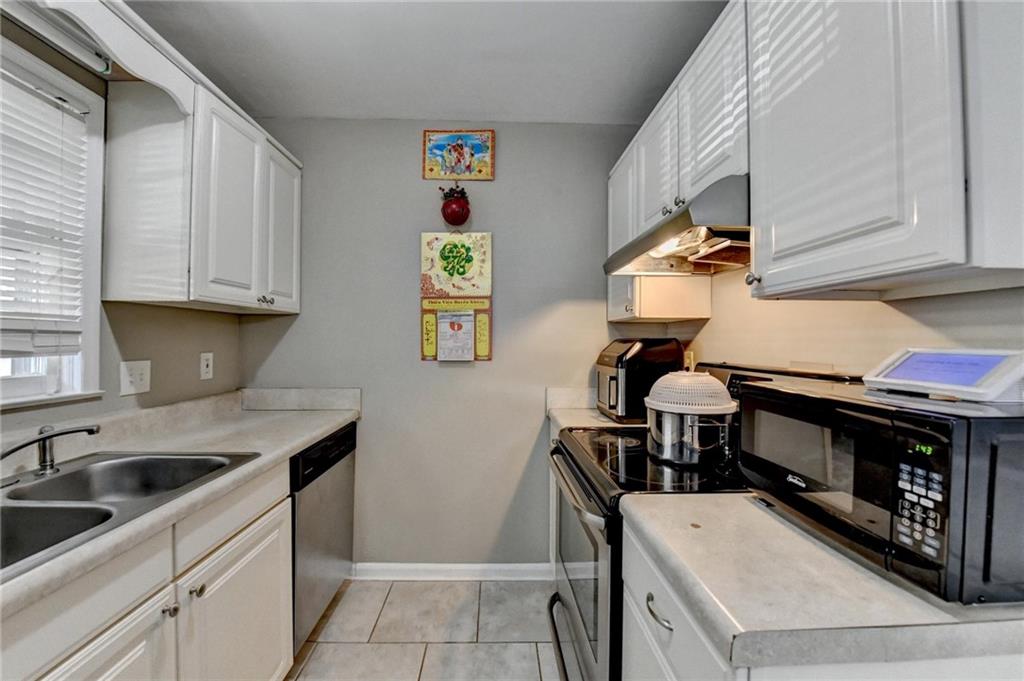 992 Old Holcomb Bridge Road Roswell, GA 30076 - Photo 14 of 34 a kitchen with a sink cabinets and window