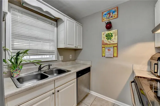 a kitchen with a refrigerator and a sink