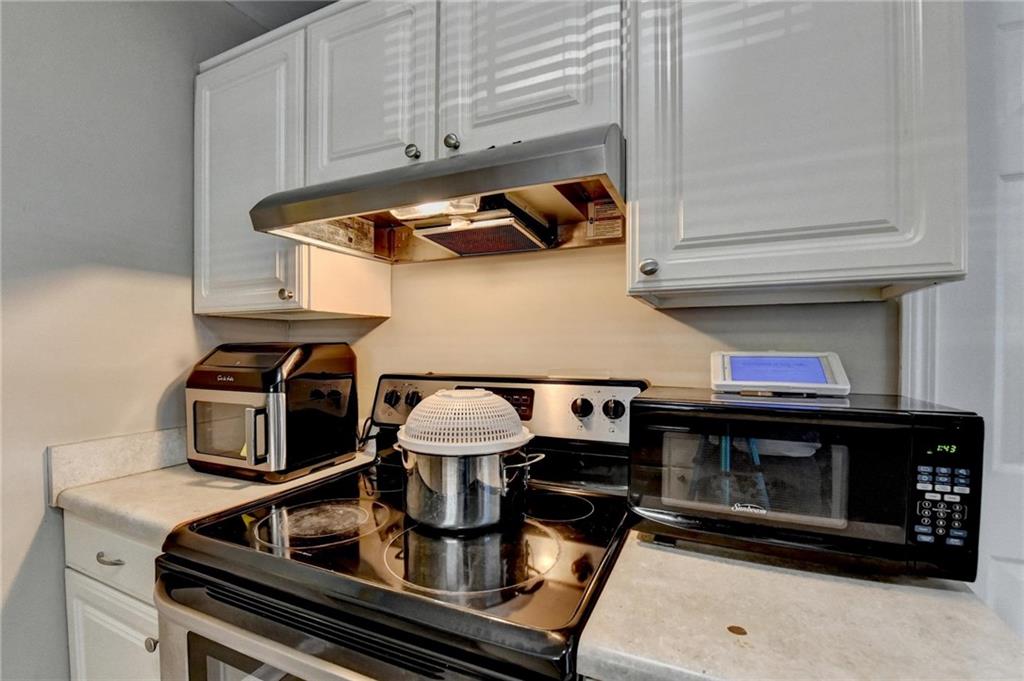 992 Old Holcomb Bridge Road Roswell, GA 30076 - Photo 16 of 34 a kitchen with a stove and a microwave