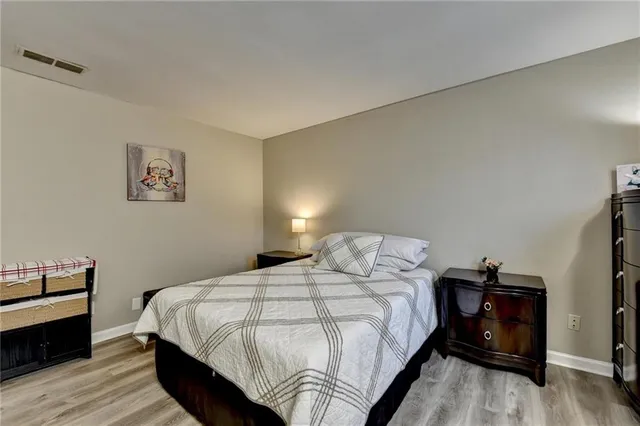 a bedroom with a bed and a night stand