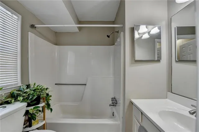 a bathroom with a shower curtain and a sink