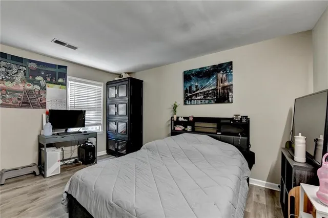 a bedroom with a bed and a flat screen tv