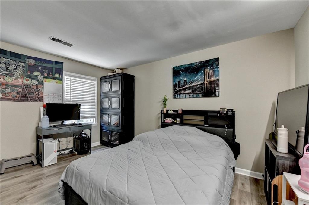 992 Old Holcomb Bridge Road Roswell, GA 30076 - Photo 26 of 34 a bedroom with a bed and a flat screen tv