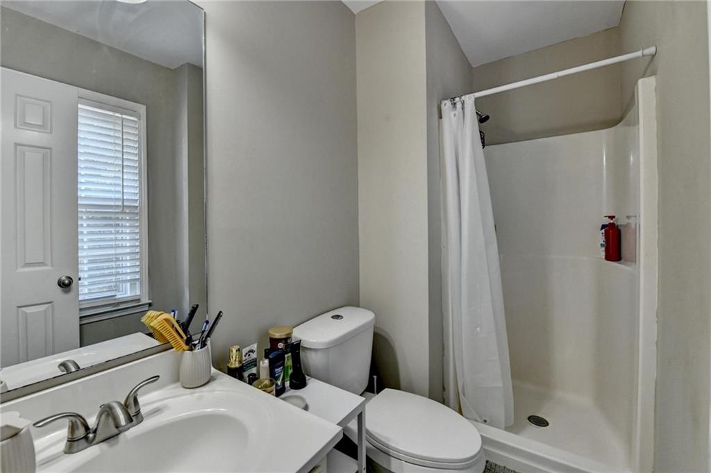 992 Old Holcomb Bridge Road Roswell, GA 30076 - Photo 29 of 34 a bathroom with a sink toilet and shower