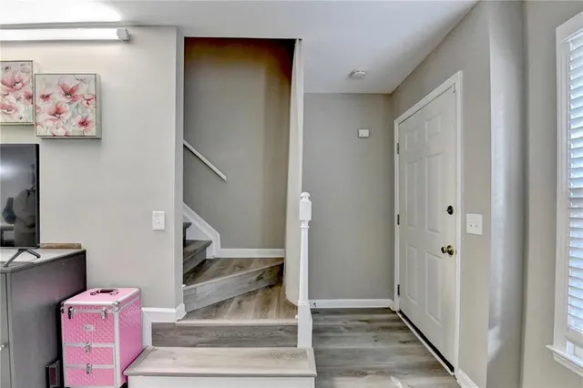 a view of a hallway with wooden floor and entryway