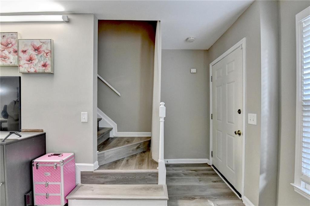 992 Old Holcomb Bridge Road Roswell, GA 30076 - Photo 5 of 34 a view of a hallway with wooden floor and entryway