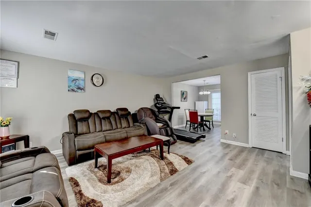 a living room with furniture and wooden floor