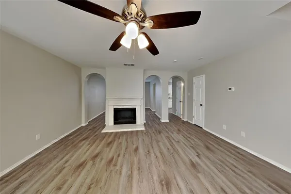 wooden floor in an empty room with a fireplace