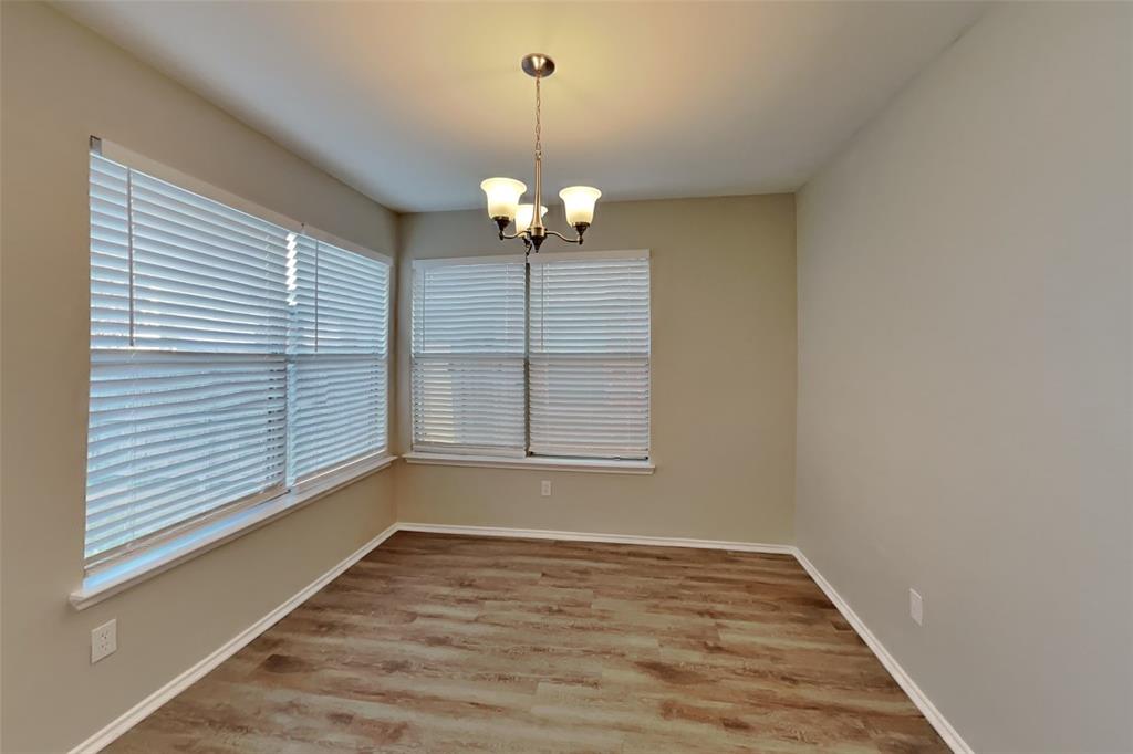 3925 Cane River Road Fort Worth, TX 76244 - Photo 5 of 21 Unfurnished dining area featuring light wood-style flooring and a chandelier