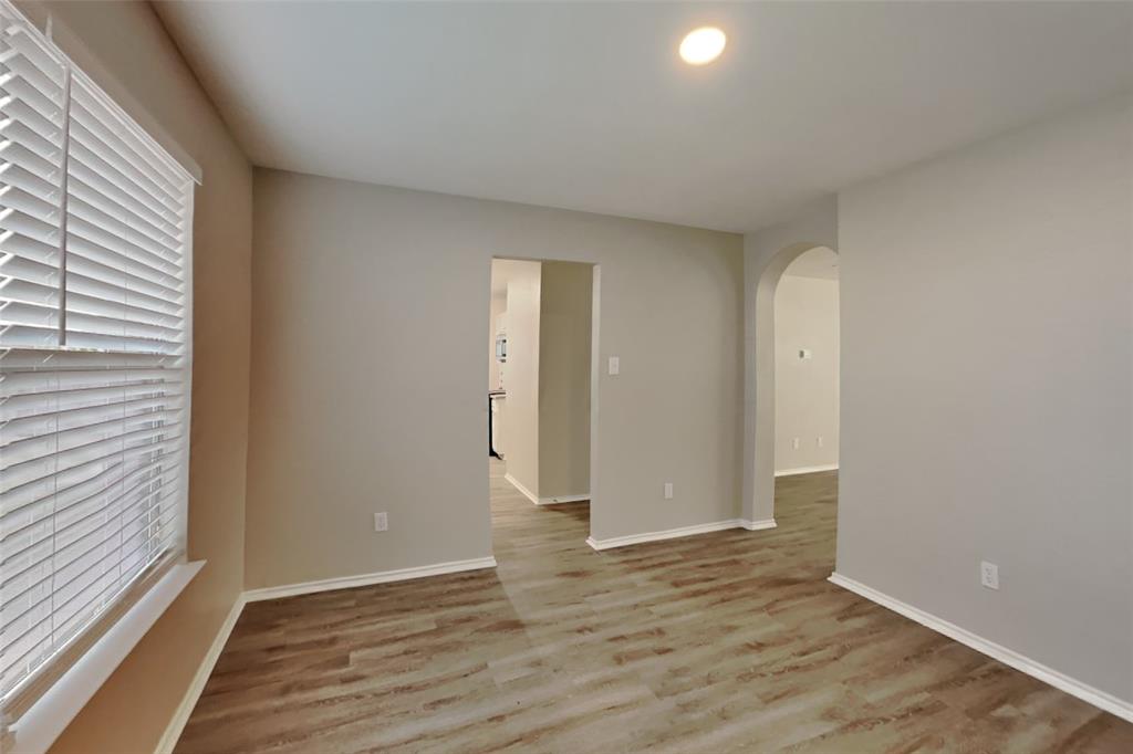 3925 Cane River Road Fort Worth, TX 76244 - Photo 7 of 21 Spare room with arched walkways, light wood-style flooring, healthy amount of natural light, and recessed lighting