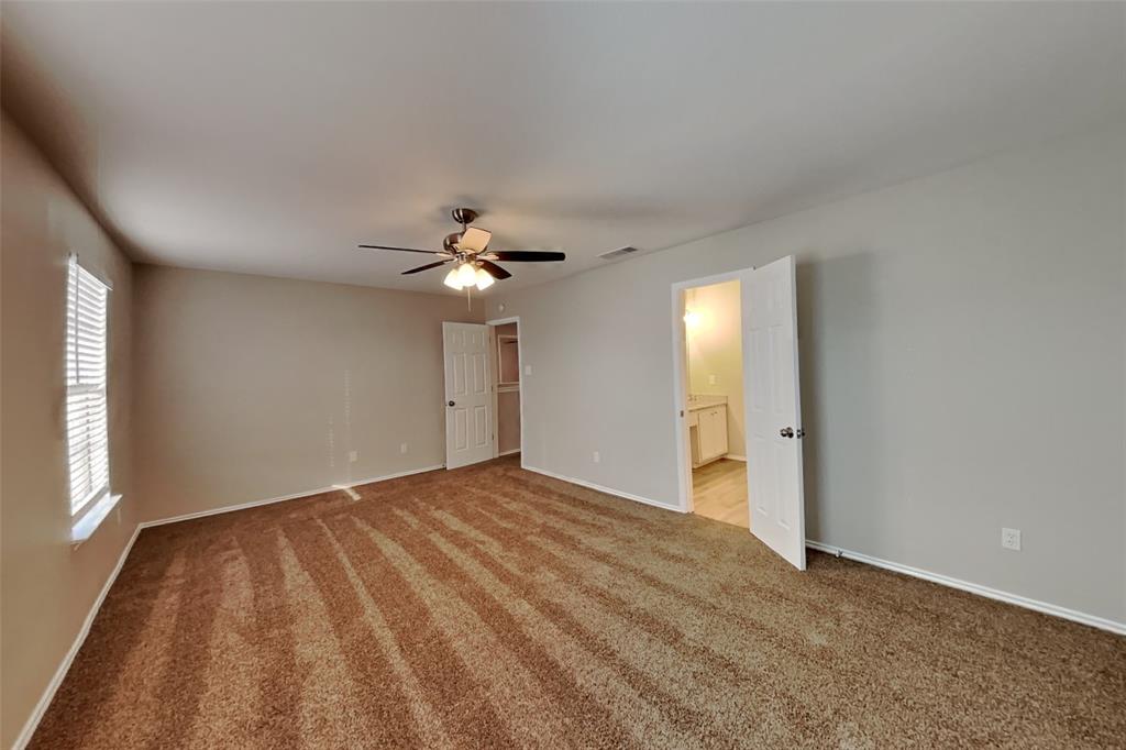 3925 Cane River Road Fort Worth, TX 76244 - Photo 8 of 21 Unfurnished bedroom with carpet, ceiling fan, and ensuite bath