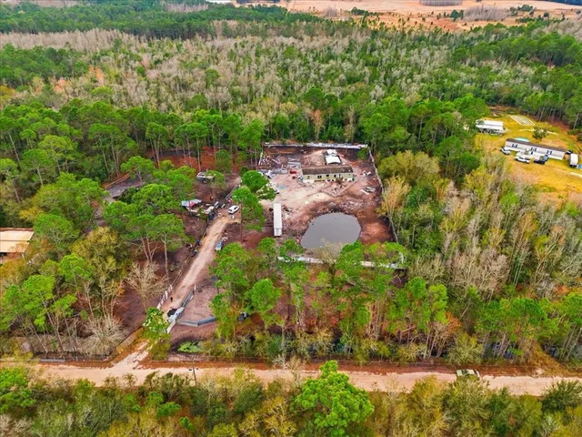 an aerial view of house with yard swimming pool and outdoor seating