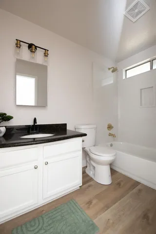a bathroom with a sink a toilet and a bathtub