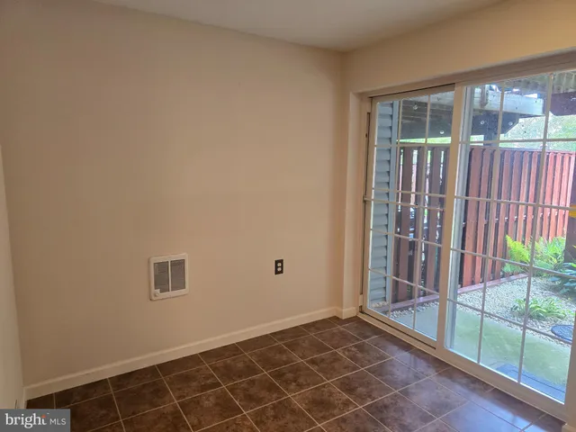 a view of a backyard with plants and a patio