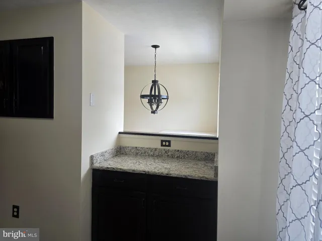 a view of a kitchen from a hallway