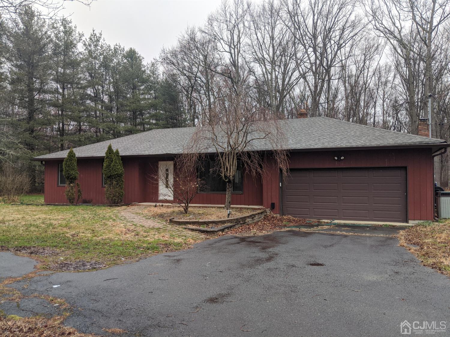 154 Broadway Road Cranbury, NJ 08512 - Photo 1 of 15 a front view of a house with a yard and garage