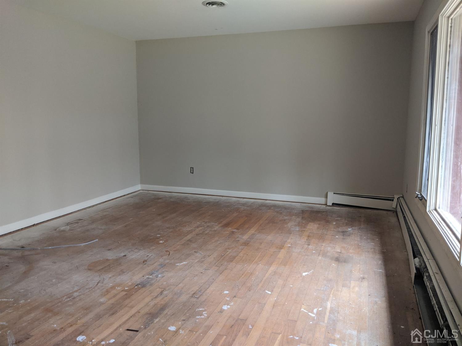 154 Broadway Road Cranbury, NJ 08512 - Photo 2 of 15 a view of a room with wooden floor and window