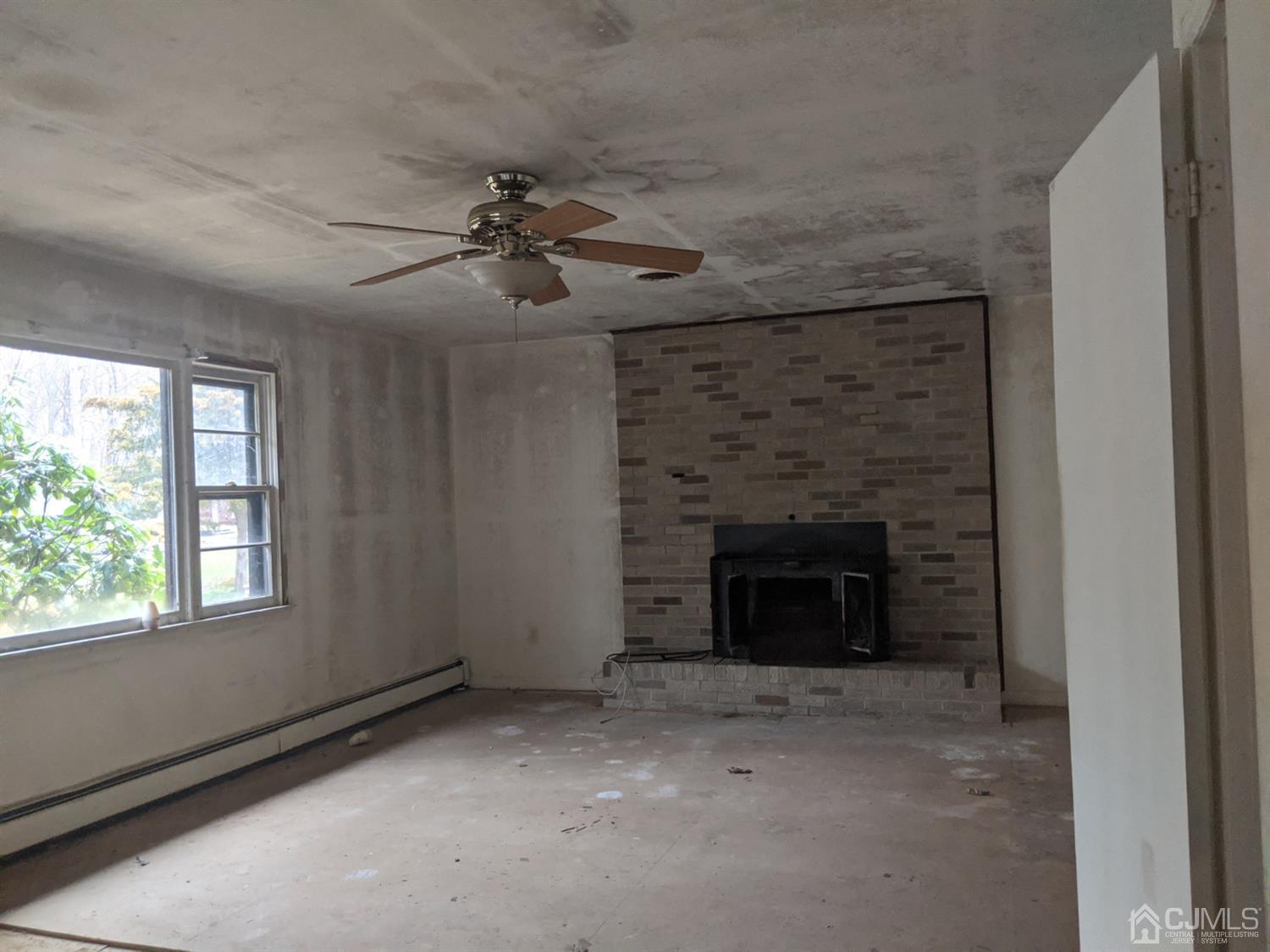 154 Broadway Road Cranbury, NJ 08512 - Photo 11 of 15 a view of a livingroom with a fireplace and a window