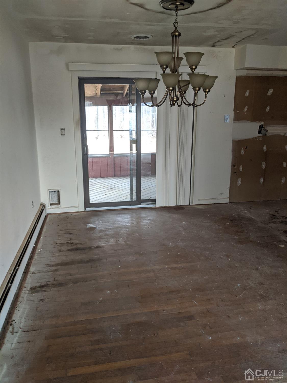154 Broadway Road Cranbury, NJ 08512 - Photo 3 of 15 a view of room with window and chandelier