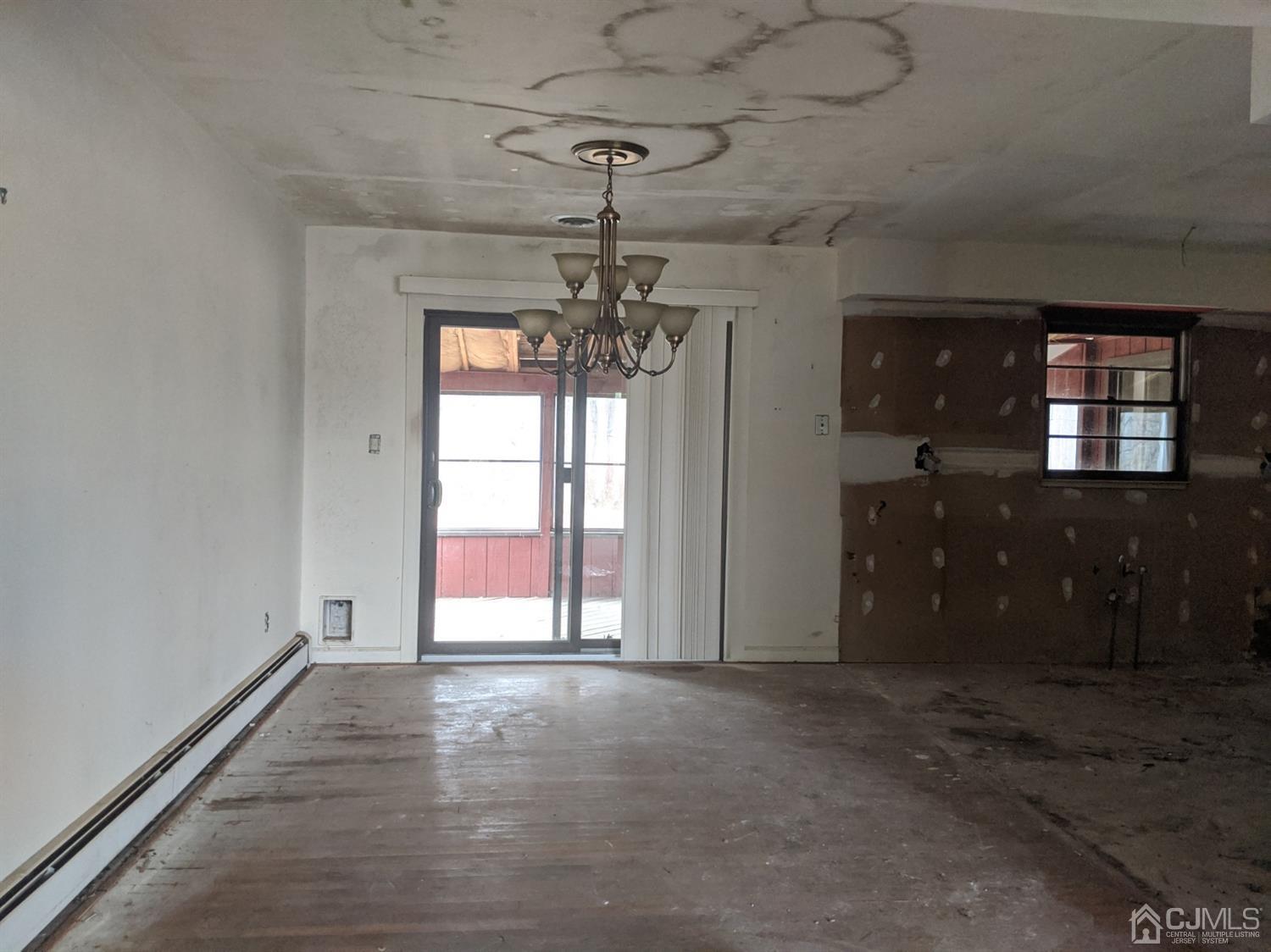 154 Broadway Road Cranbury, NJ 08512 - Photo 8 of 15 wooden floor in an empty room with a window