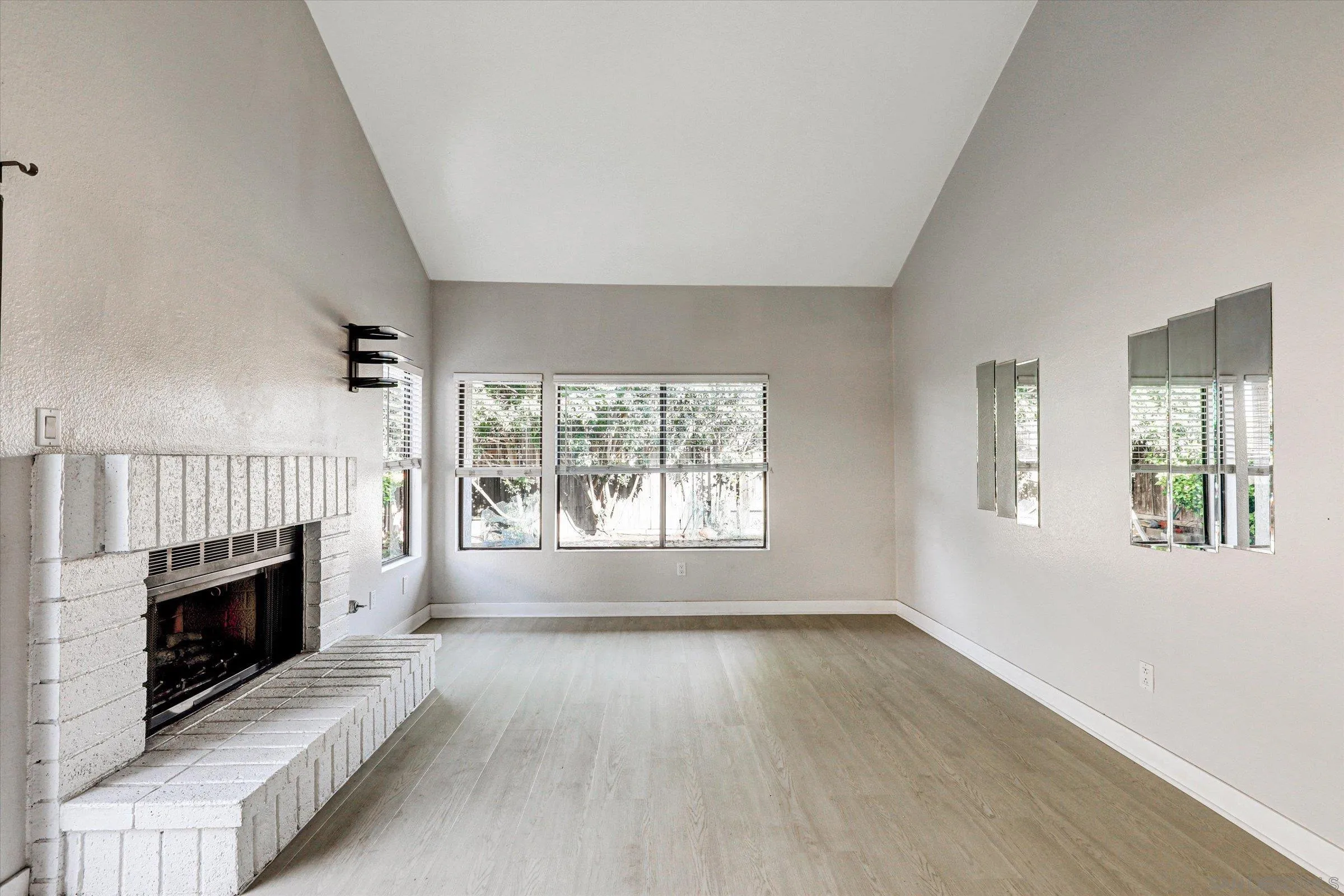 9488 Hiker Hill Road San Diego, CA 92129 - Photo 13 of 27 an empty room with windows and fireplace
