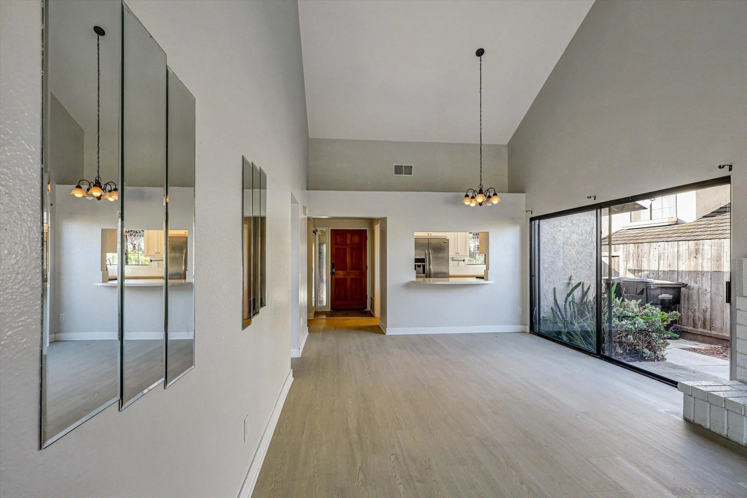 9488 Hiker Hill Road San Diego, CA 92129 - Photo 15 of 27 a view of a hallway with wooden floor and a living room