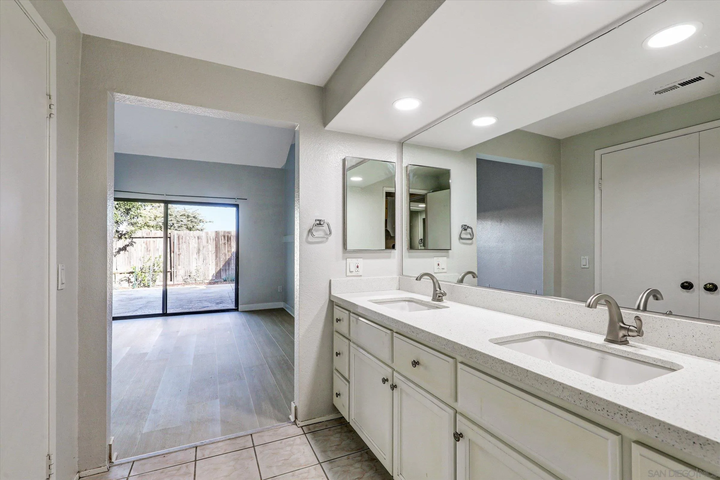 9488 Hiker Hill Road San Diego, CA 92129 - Photo 20 of 27 a spacious bathroom with a double vanity sink and a mirror