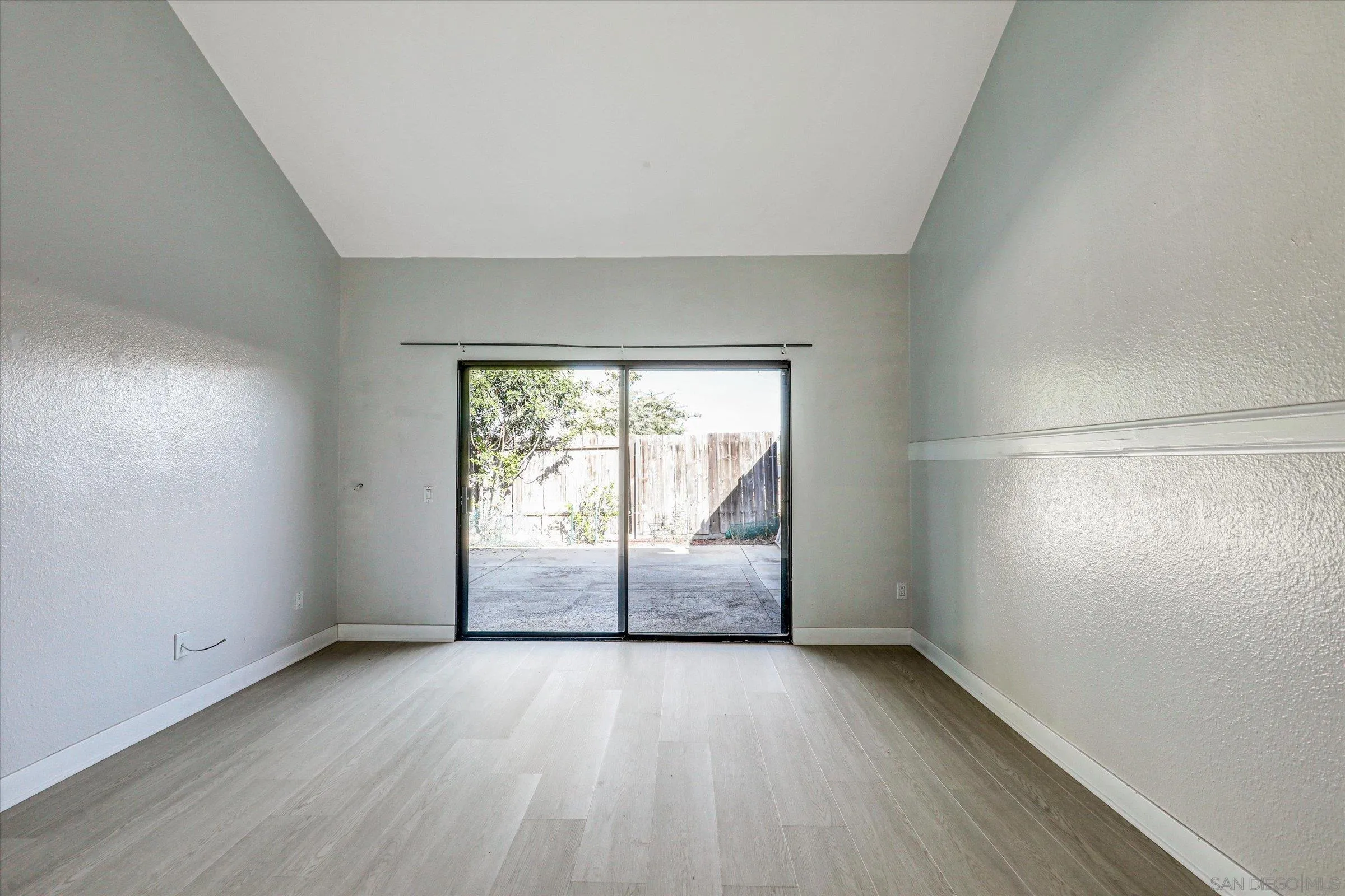9488 Hiker Hill Road San Diego, CA 92129 - Photo 24 of 27 an empty room with wooden floor and windows