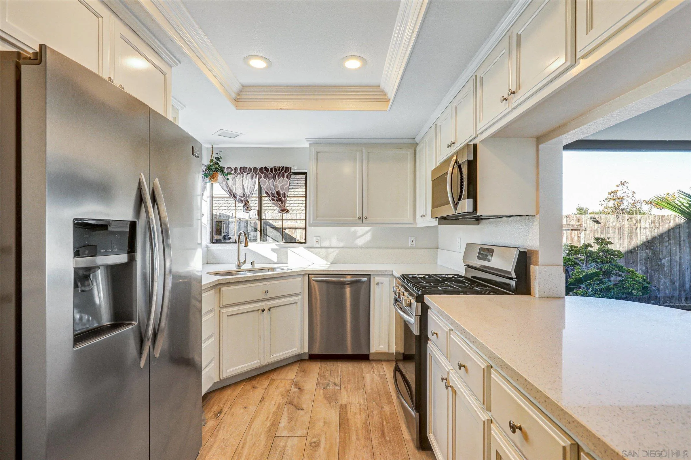 9488 Hiker Hill Road San Diego, CA 92129 - Photo 9 of 27 a kitchen with a sink stove and refrigerator