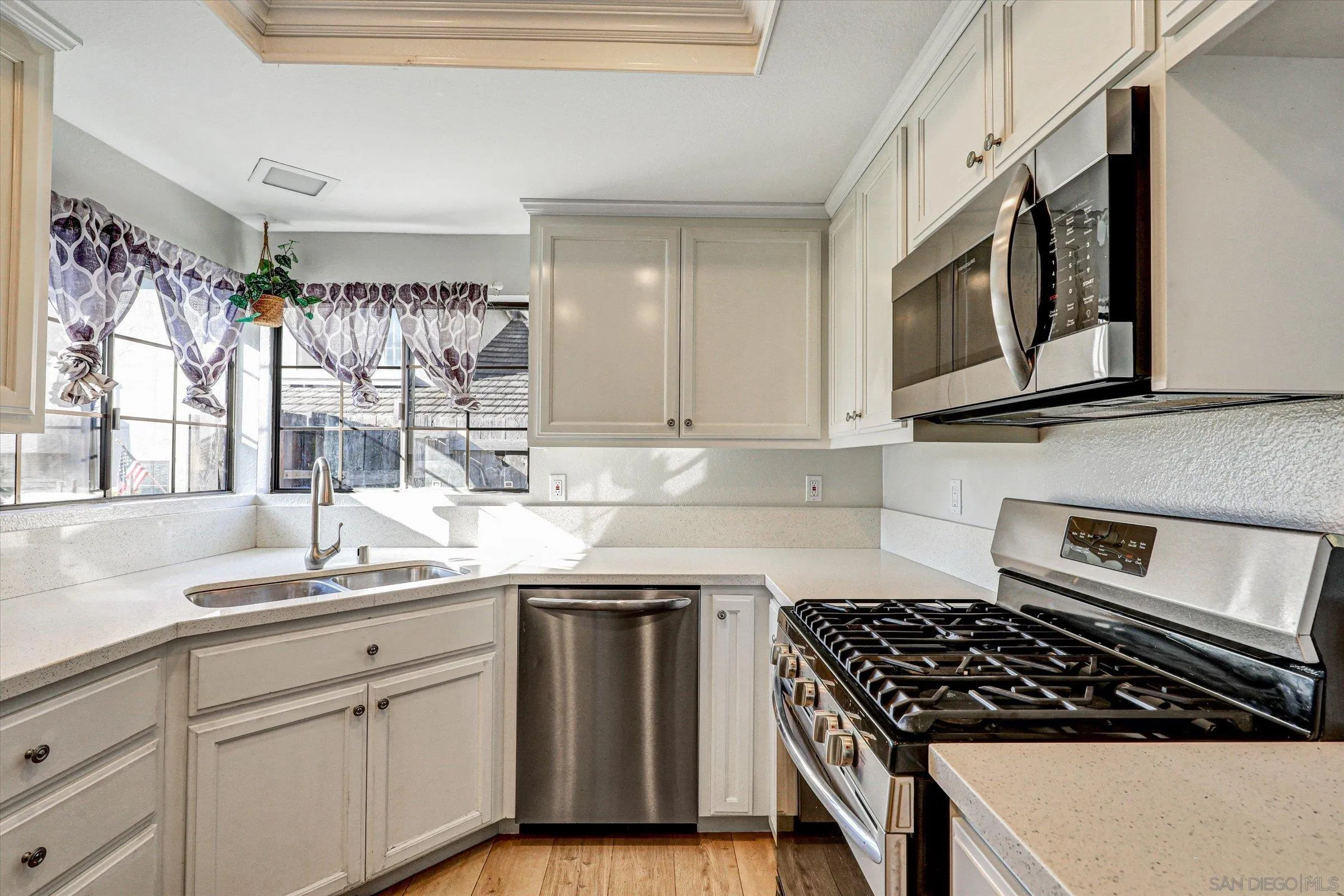 9488 Hiker Hill Road San Diego, CA 92129 - Photo 10 of 27 a kitchen with stainless steel appliances a sink dishwasher stove and microwave