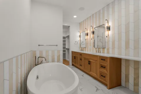 a bathroom with double vanity sink and mirror