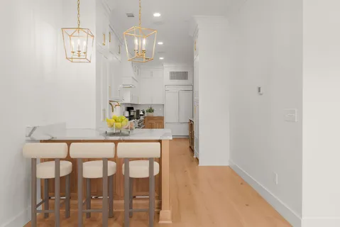 a dining room with furniture and chandelier