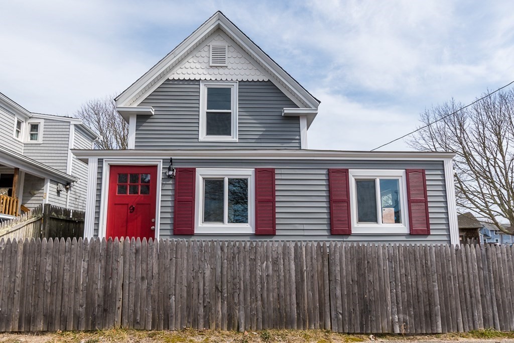 a front view of a house with a fence