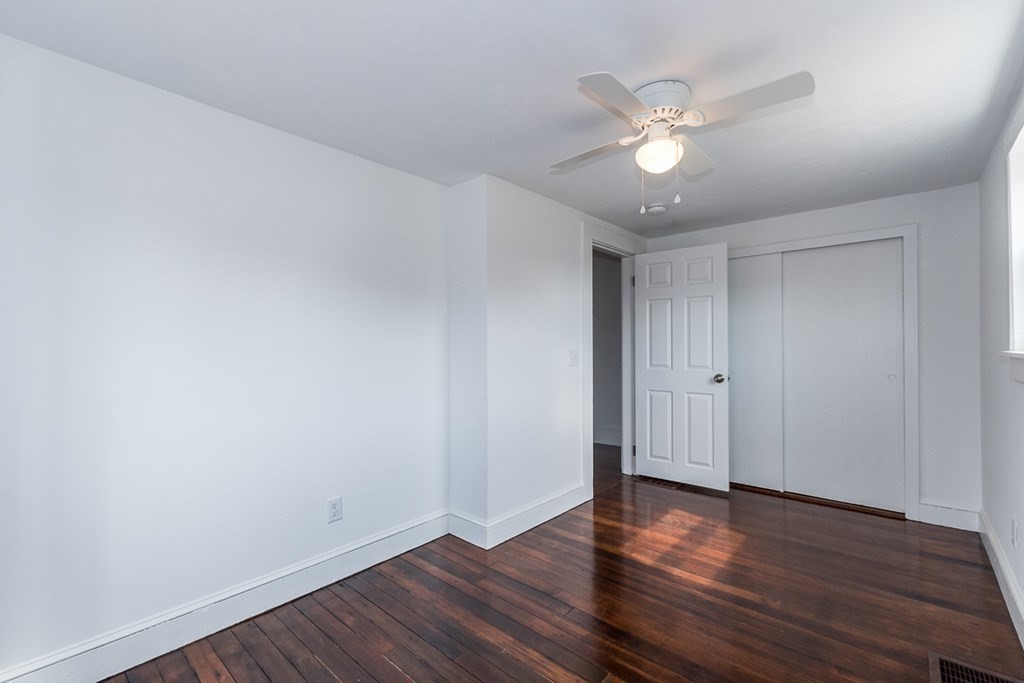9 Camp Street Wareham, MA 02558 - Photo 18 of 30 a view of an empty room with wooden floor and a ceiling fan