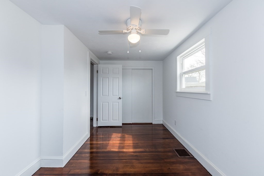 9 Camp Street Wareham, MA 02558 - Photo 19 of 30 a view of an empty room with wooden floor and a window