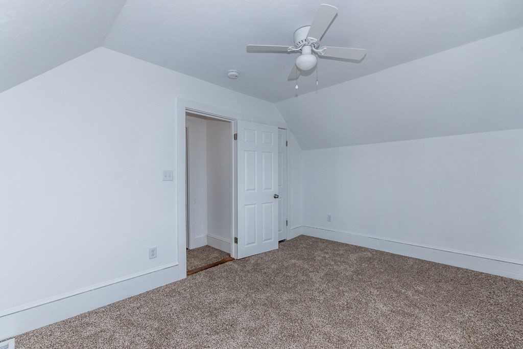 9 Camp Street Wareham, MA 02558 - Photo 23 of 30 an empty room with a ceiling fan and a window