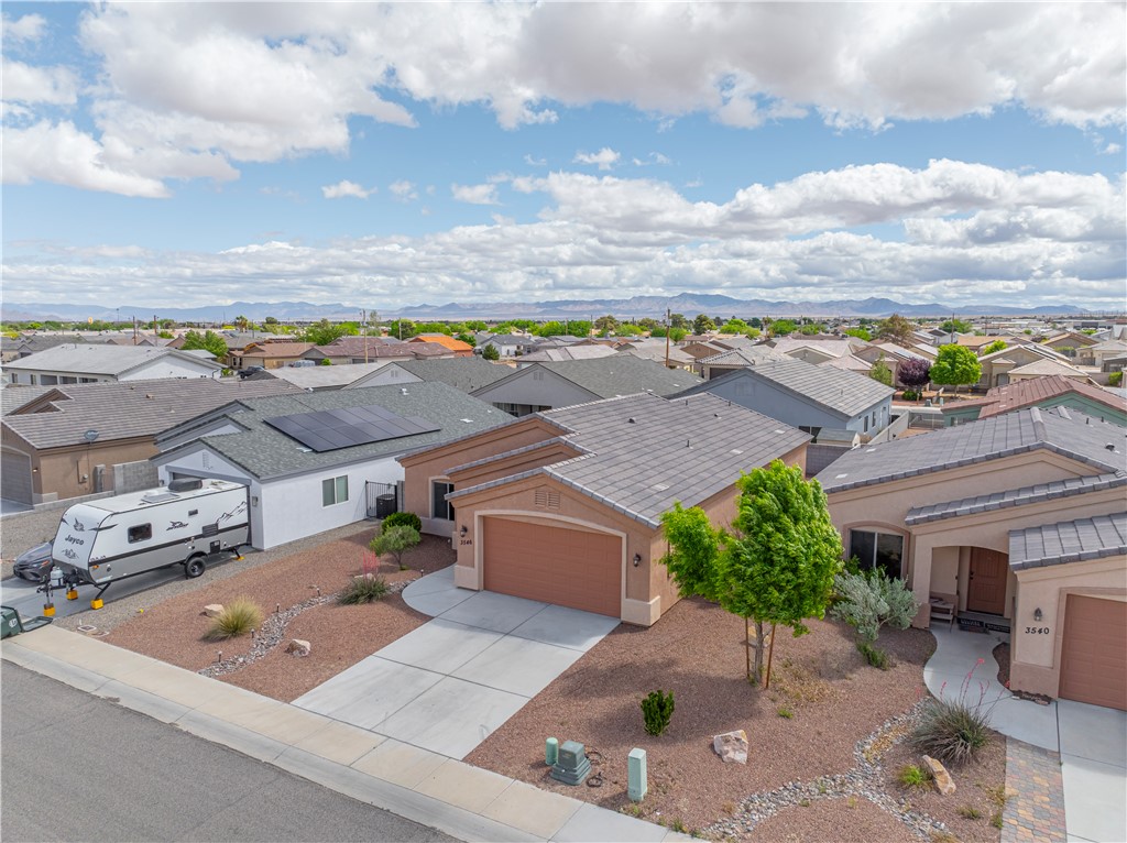 3546 North Kenneth Road Kingman, AZ 86409 - Photo 27 of 35 The property features a concrete driveway and an attached garage