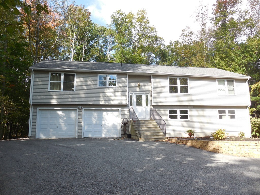 5 Kingsbury Road Webster, MA 01570 - Photo 21 of 29 a front view of a house with a yard and garage