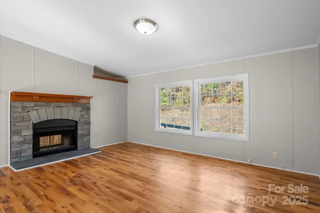 a view of empty room with a fireplace