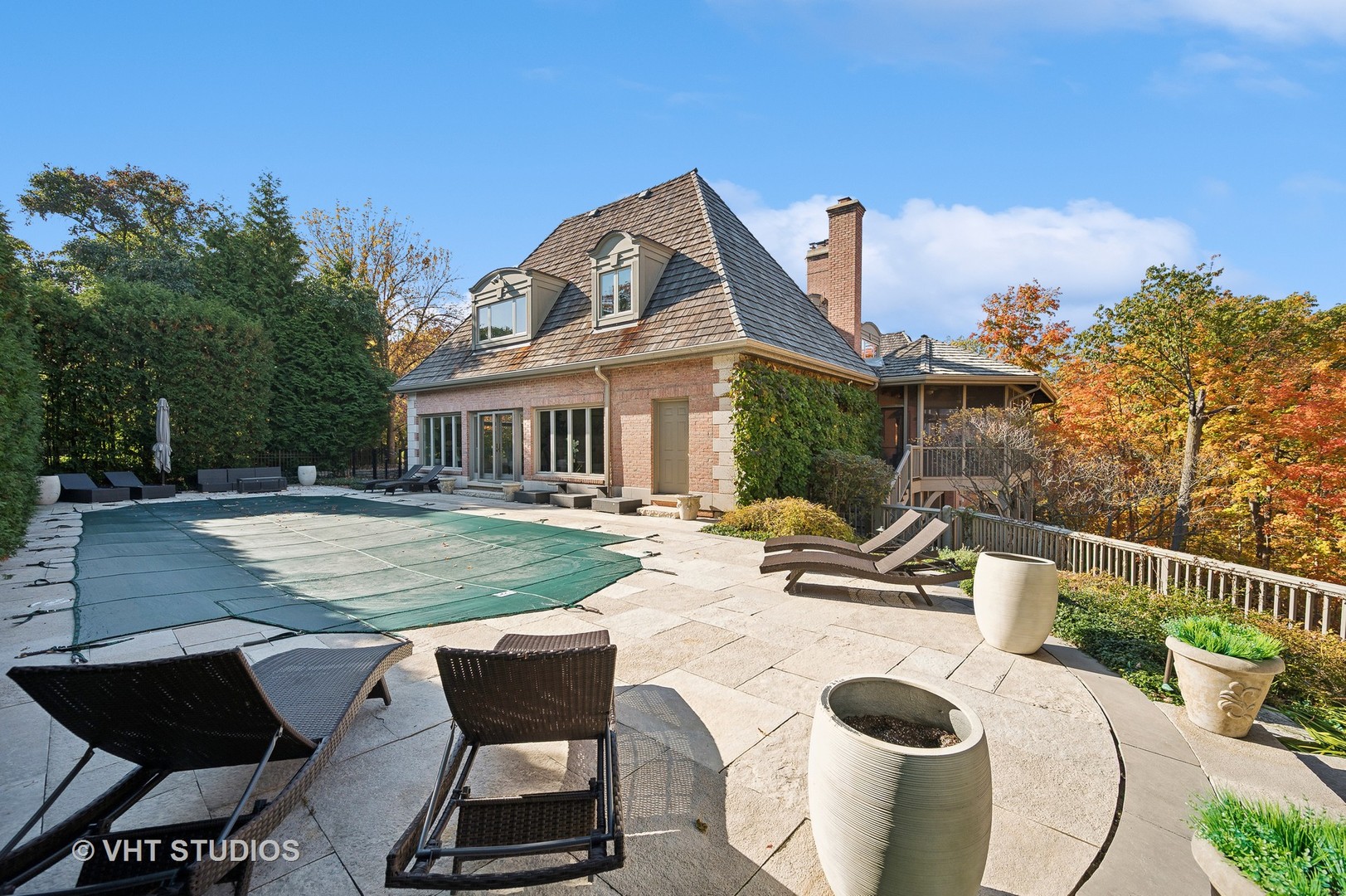 1015 Sheridan Road Glencoe, IL 60022 - Photo 22 of 29 a view of a white house with a swimming pool and sitting area