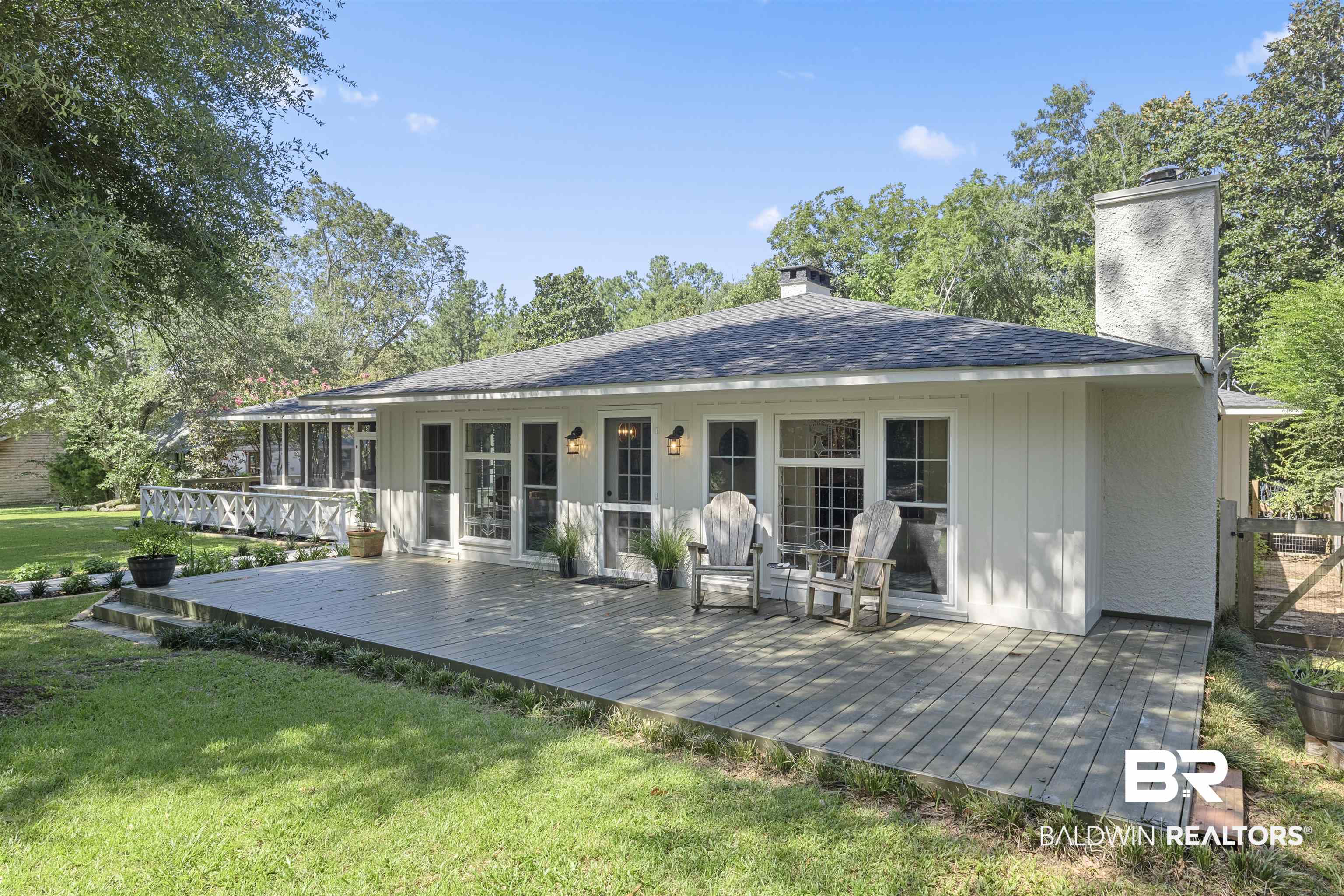 15100 Vasko Road Silverhill, AL 36576 - Photo 40 of 51 Rear view of house featuring a wooden deck and a yard