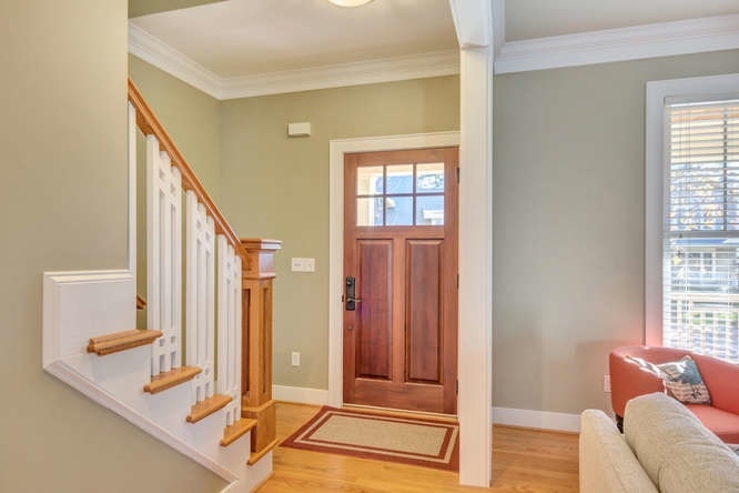 Welcoming entryway shows off many of the Arts & Crafts features.