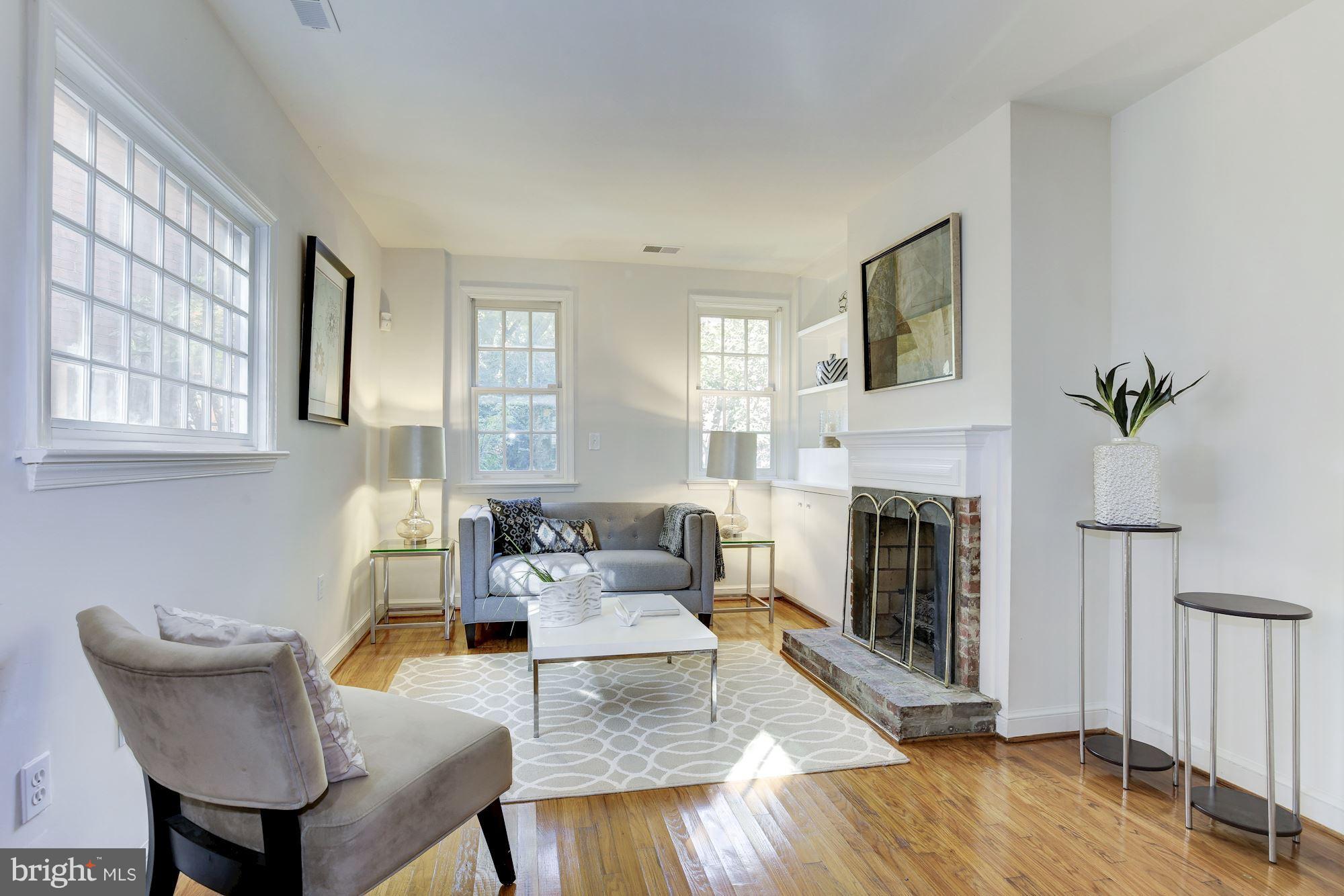 1341 Vermont Avenue Northwest Washington, DC 20005 - Photo 1 of 29 a living room with furniture and a fireplace