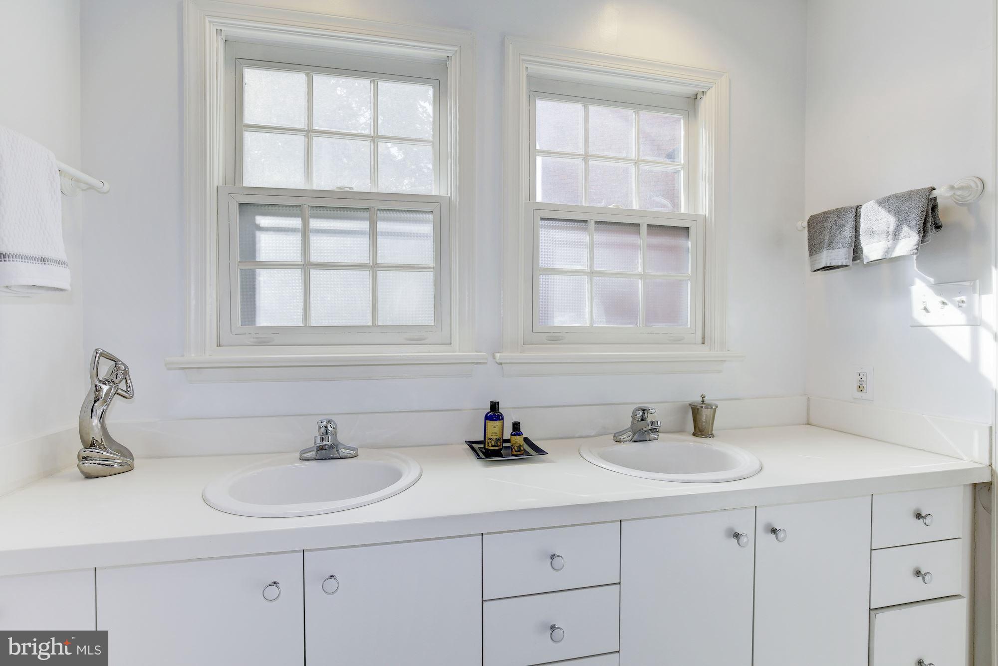1341 Vermont Avenue Northwest Washington, DC 20005 - Photo 15 of 29 a bathroom with double sink and a mirror