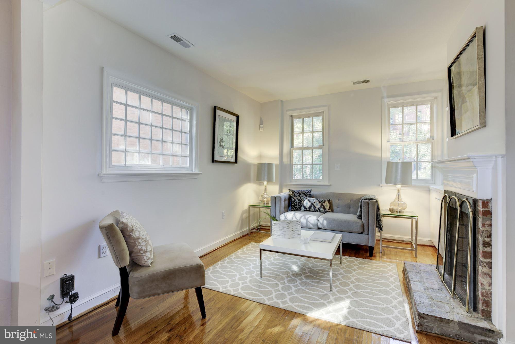 1341 Vermont Avenue Northwest Washington, DC 20005 - Photo 4 of 29 a living room with fireplace furniture and a rug