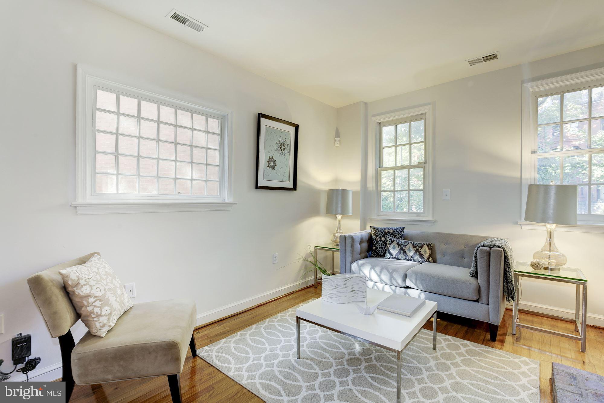 1341 Vermont Avenue Northwest Washington, DC 20005 - Photo 5 of 29 a living room with furniture and a window
