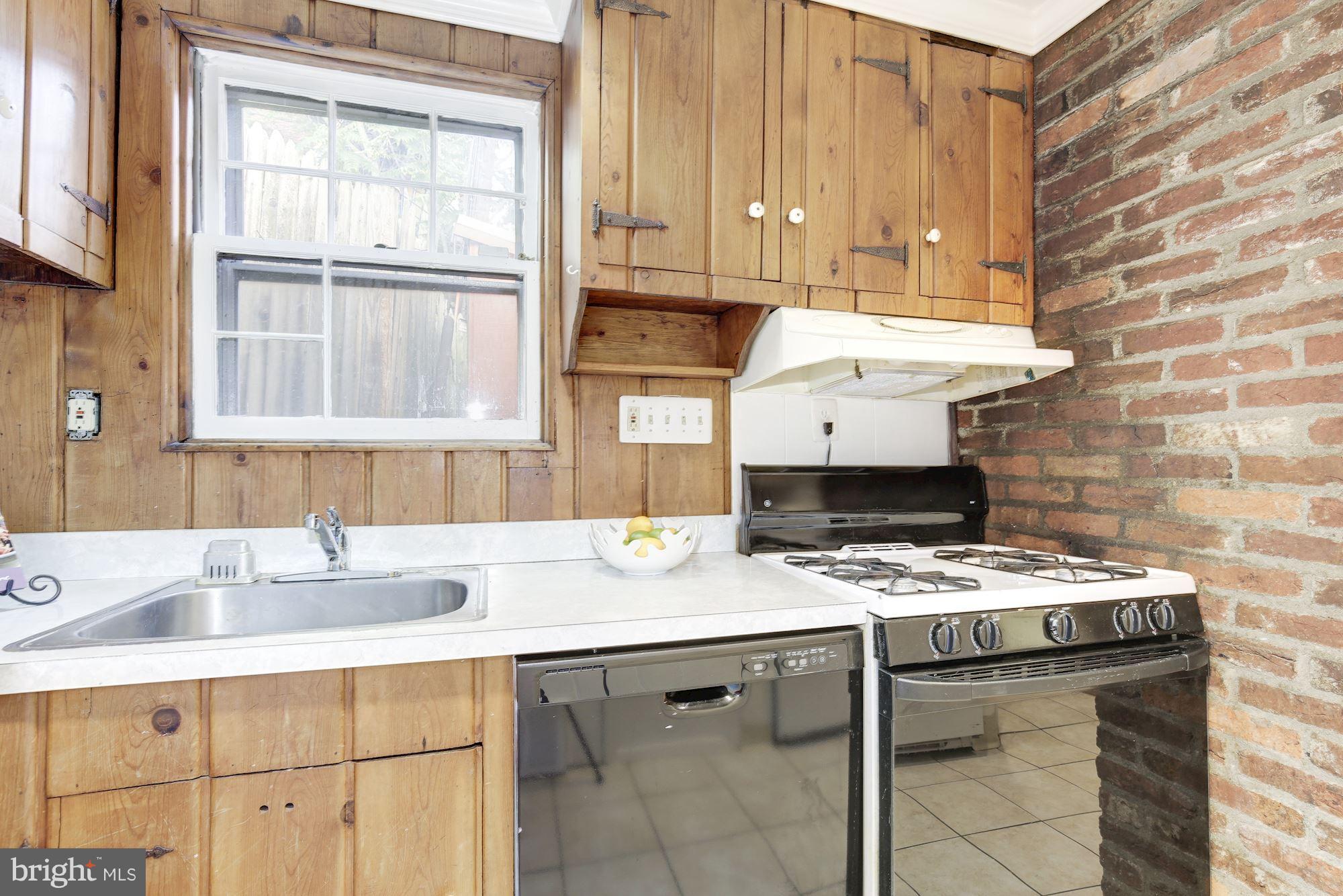 1341 Vermont Avenue Northwest Washington, DC 20005 - Photo 10 of 29 a kitchen with a sink stove and cabinets