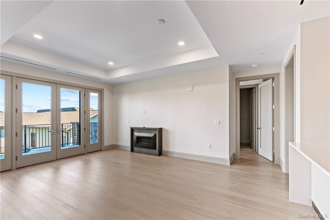 120 Old Post Road, Unit PHE303 Rye, NY 10580 - Photo 6 of 29 wooden floor in an empty room with a fireplace